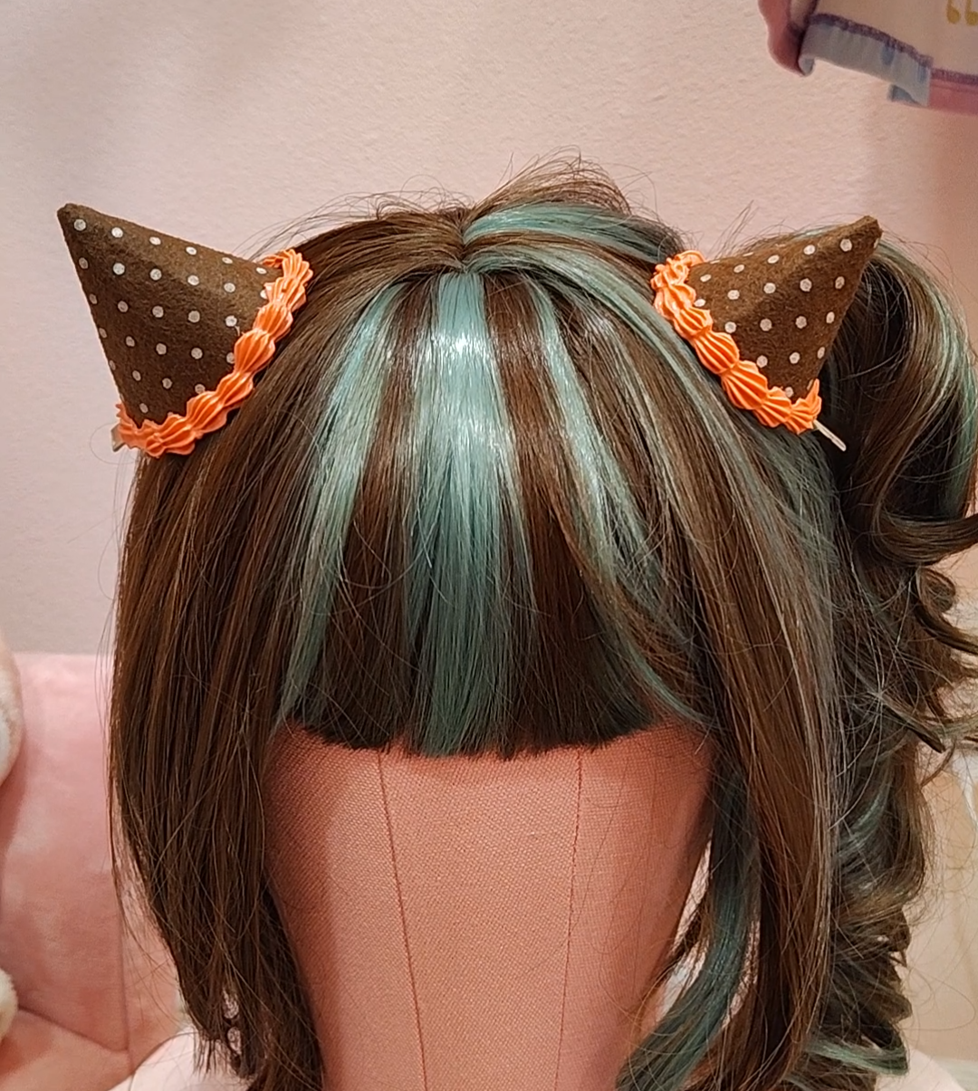 Brown devil horn hair clip accessory with white polkadots and orange decoden cream.