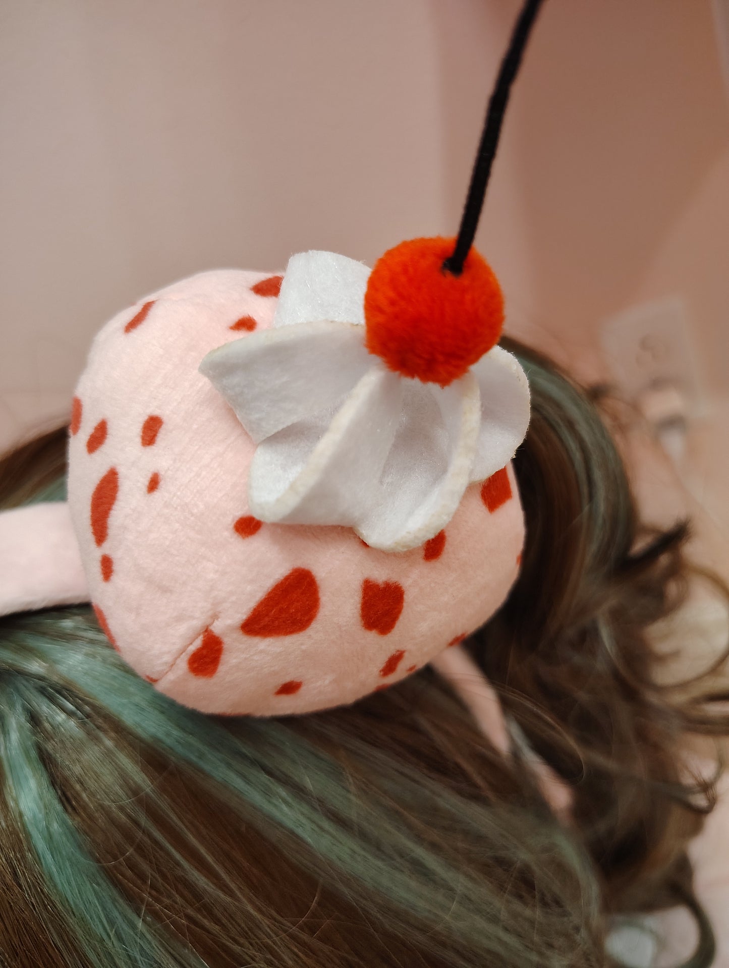 Plush headband detail resembling an ice cream scoop with whipped cream and a cherry.
