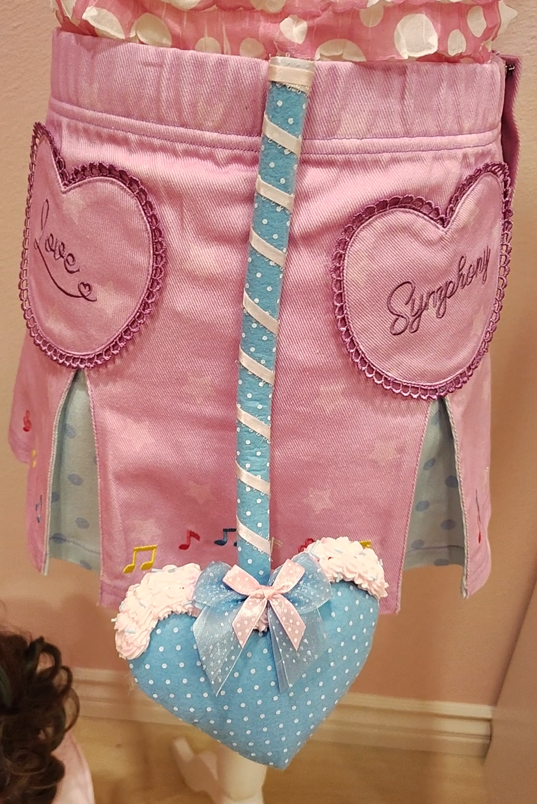 Blue devil tail accessory with white polkadots, silver ribbon, and decoden cream