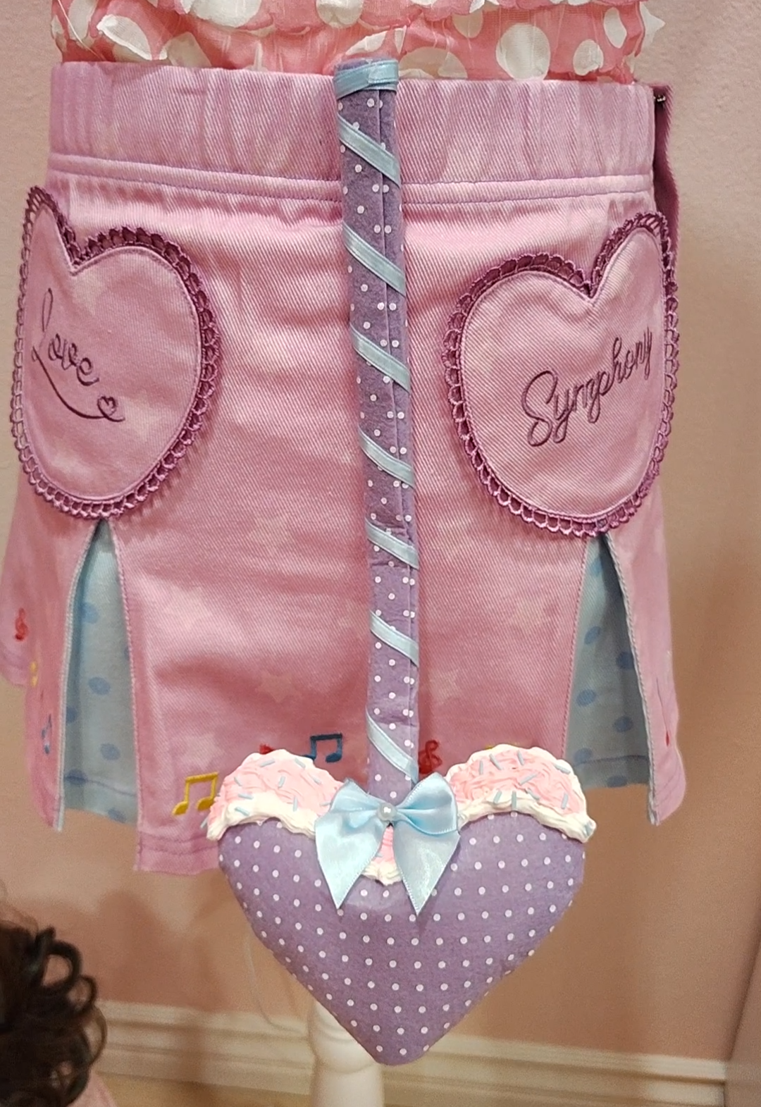 Purple devil tail with white polkadots, a heart prong, blue ribbon, and decoden cream.